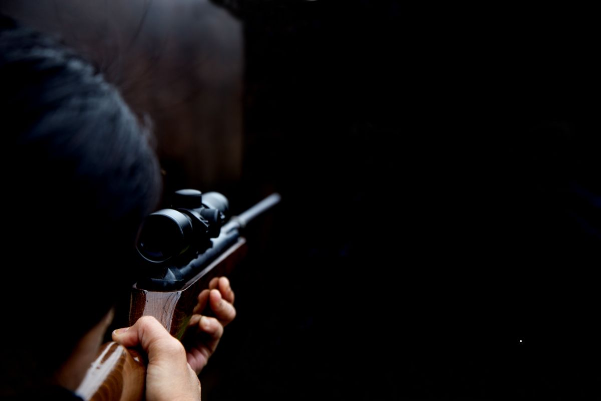 Assassin Pointing a Rifle