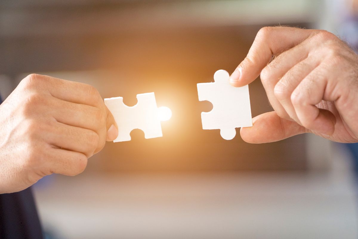 Putting to puzzle pieces together to form a connection.