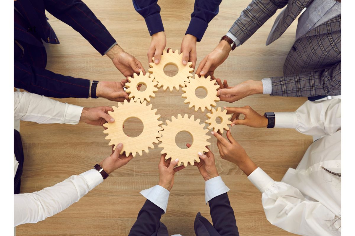 Circle of hands with gears