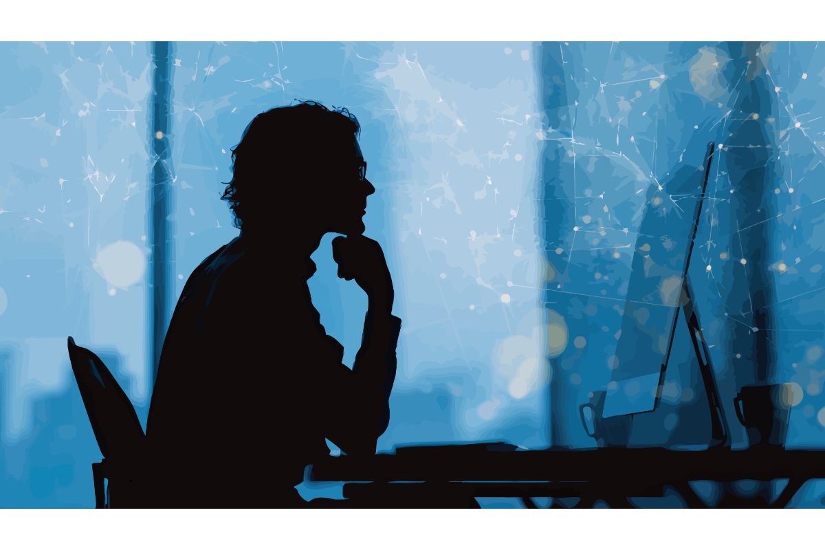 A person in front of a computer monitor contemplating deeply.