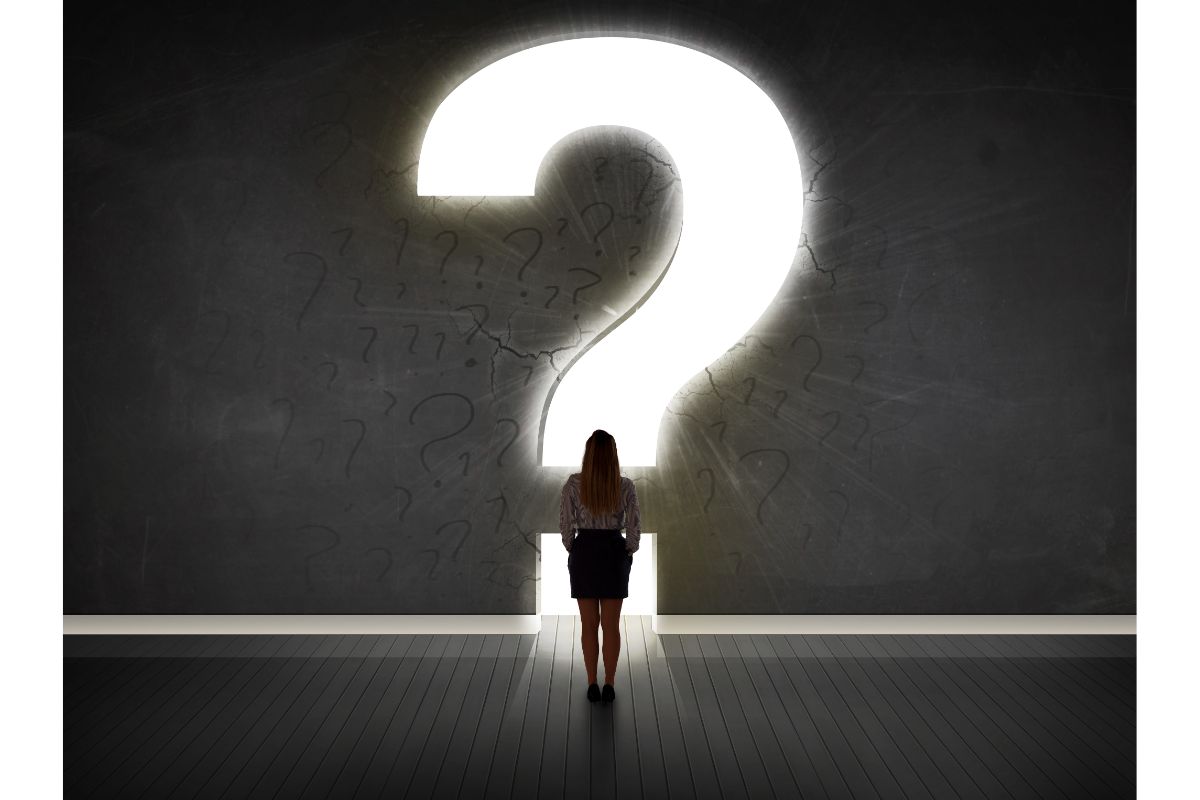 Lady standing in front of a Question Mark